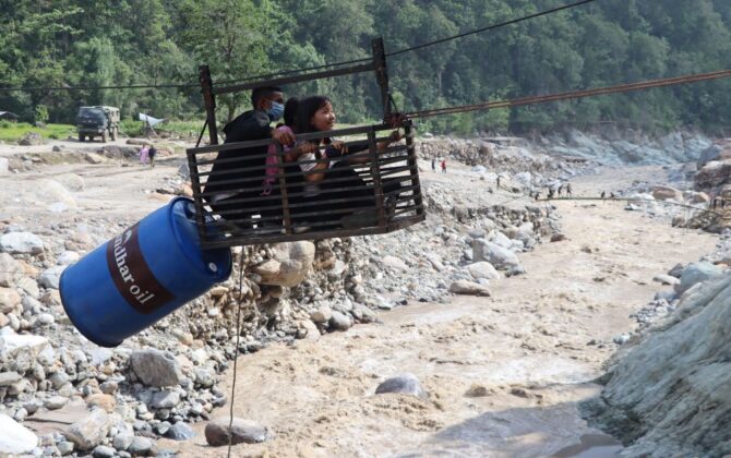 मेची राजमार्गअन्तर्गत पाँचथरको हेवा खोलामा रहेको मोटरेवल पुल पहिरोले क्षति पुराएपछि तुइनबाट खोला तर्दै सर्वसाधारण ।